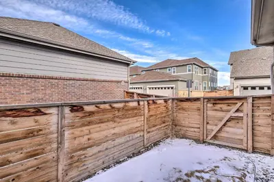 a wooden fence in front of a house at Charming 3BR Retreat - Perfect for Families in Fort Collins