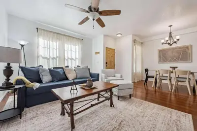 a living room with a blue couch and a table at 3BR Modern Retreat, Close to DIA & Downtown Denver in Commerce City