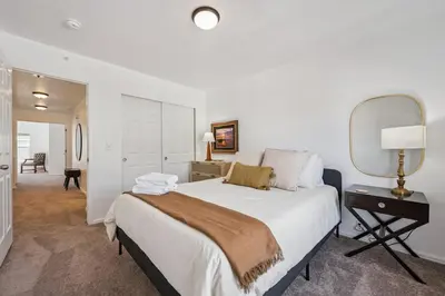 a bedroom with a large bed and a mirror at 3BR Modern Retreat, Close to DIA & Downtown Denver in Commerce City