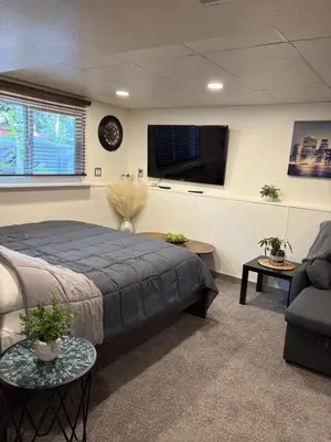 a bedroom with a bed and a flat screen tv at The Cozy nest in Englewood