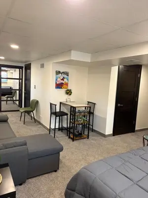 a room with a bed and a table and chairs at The Cozy nest in Englewood