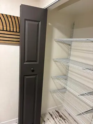 a closet with empty shelves and a door at The Cozy nest in Englewood