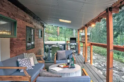 a screened in porch with a couch and a table at Dog Friendly, Year Round, Creekside Cabin, Hot Tub, 6 Acres in Jamestown
