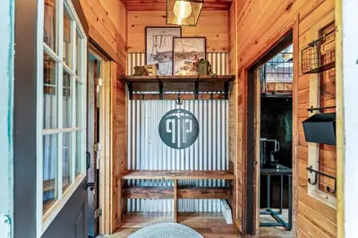 a porch with a bench in a wooden house at Dog Friendly, Year Round, Creekside Cabin, Hot Tub, 6 Acres in Jamestown