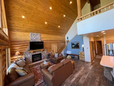 a living room with a couch and a fireplace at Granby Panoramic Paradise! Hot tub and firepit! in Granby