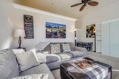 a living room with a couch and a ceiling fan at 2795 Slopeside condo in Keystone