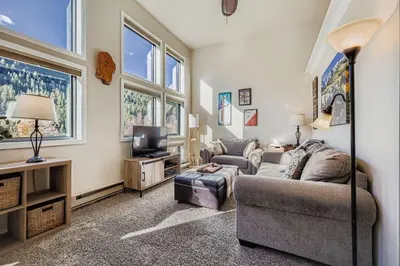 a living room with a couch and a tv at 2795 Slopeside condo in Keystone