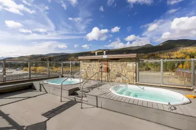 a patio with two hot tubs on a deck at 2795 Slopeside condo in Keystone