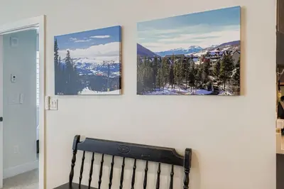 three pictures hanging on a wall with a bench at 305 Brightwood at Keystone condo in Keystone