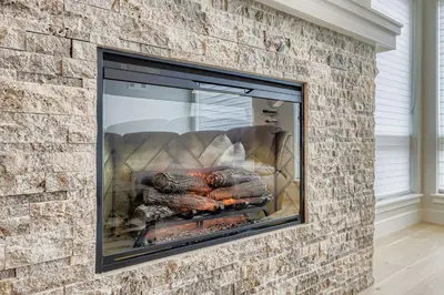 a brick fireplace with meat on a grill at 305 Brightwood at Keystone condo in Keystone