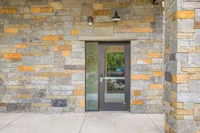 a stone building with a glass door in front of it at 305 Brightwood at Keystone condo in Keystone