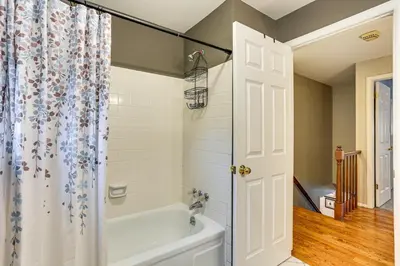 a bathroom with a tub and a shower curtain at Spacious Family Home with Deck and Yard in Littleton! in Littleton