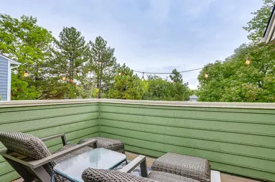 a patio with chairs and a table and a fence at Spacious Family Home with Deck and Yard in Littleton! in Littleton