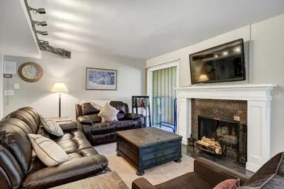 a living room with a couch and a fireplace at Keystone Mtn Getaway - Cozy Condo for 4 in Keystone
