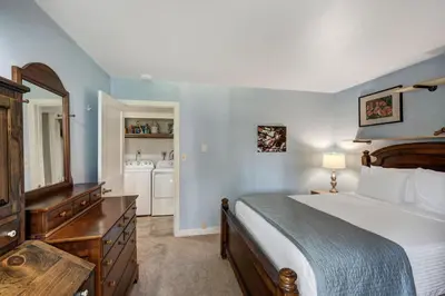 a bedroom with a bed and a dresser with a mirror at Keystone Mtn Getaway - Cozy Condo for 4 in Keystone