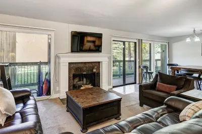 a living room with couches and a fireplace at Keystone Mtn Getaway - Cozy Condo for 4 in Keystone