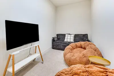 a living room with a tv and a couch at Family Haven, Walk to Dtwn Erie Bring Your Pets! in Erie
