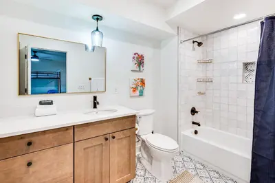 a bathroom with a sink and a tub and a toilet at Family Haven, Walk to Dtwn Erie Bring Your Pets! in Erie