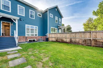 a blue house with a fence and a yard at Family Haven, Walk to Dtwn Erie Bring Your Pets! in Erie