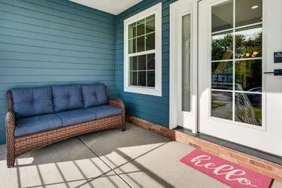a couch sitting on the front porch of a house at Family Haven, Walk to Dtwn Erie Bring Your Pets! in Erie