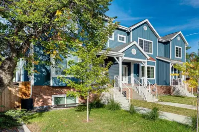 a blue house with a tree at Family Haven, Walk to Dtwn Erie Bring Your Pets! in Erie