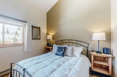 a bedroom with a large bed with a window at Timber Ridge Escape in Silverthorne