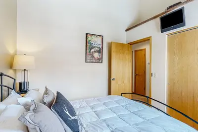 a bedroom with a bed and a television on the wall at Timber Ridge Escape in Silverthorne