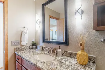 a bathroom with a sink and a mirror at Timber Ridge Escape in Silverthorne