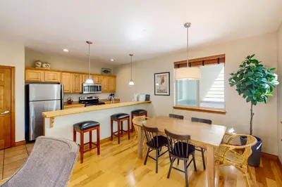 a kitchen and dining room with a table and chairs at Blue River Bliss in Silverthorne