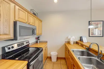 a kitchen with a sink and a stove top oven at Blue River Bliss in Silverthorne