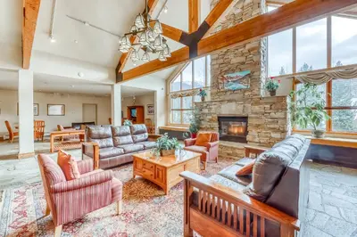 a living room with couches and a stone fireplace at Gateway 5059 in Keystone
