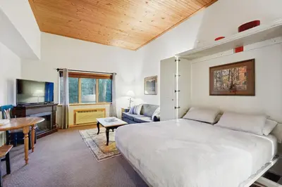 a bedroom with a large white bed and a table at Gateway 5059 in Keystone