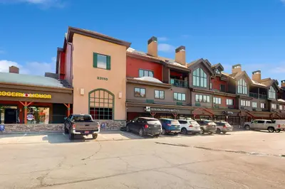 a large building with cars parked in a parking lot at Gateway 5059 in Keystone