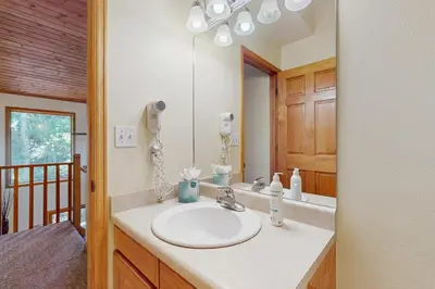 a bathroom with a sink and a mirror at Riverview Condo #4 in Grand Lake