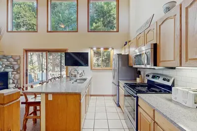 a kitchen with wooden cabinets and a counter top at Riverview Condo #4 in Grand Lake