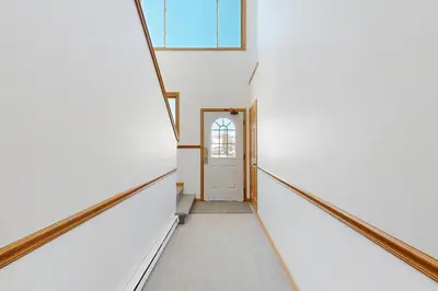 a hallway with white walls and a door at Riverview Condo #5 in Grand Lake