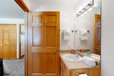 a bathroom with a sink and a mirror at Riverview Condo #5 in Grand Lake