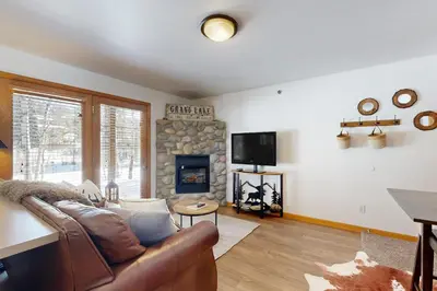 a living room with a couch and a fireplace at Riverview Condo #5 in Grand Lake