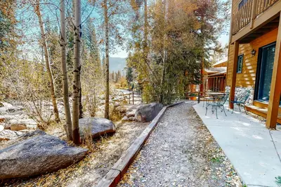 a porch of a house with two large rocks at Riverview Condo #5 in Grand Lake