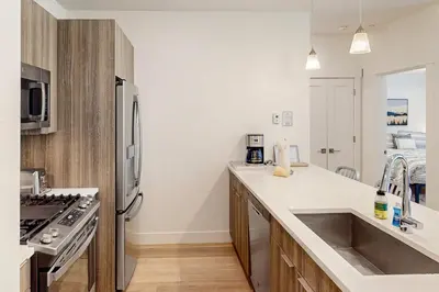 a kitchen with a sink and a stainless steel refrigerator at Blue River Dream in Silverthorne