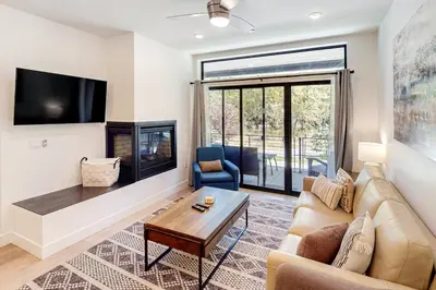 a living room with a couch and a fireplace at Blue River Dream in Silverthorne