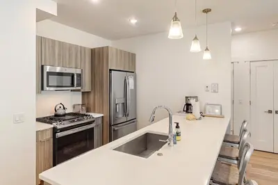 a kitchen with a sink and a stove top oven at Blue River Dream in Silverthorne