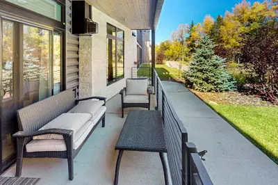 a porch with chairs and benches on a house at Blue River Dream in Silverthorne
