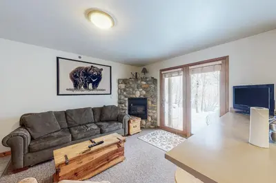 a living room with a couch and a television at Riverview Condo #7 in Grand Lake