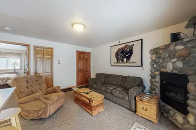 a living room with a couch and a fireplace at Riverview Condo #7 in Grand Lake