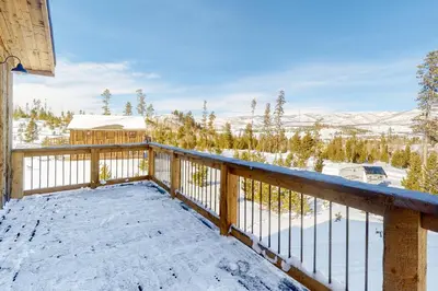 a winter view from the balcony of a cabin at Square House in Grand Lake