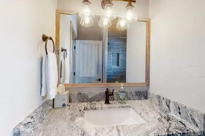 a bathroom with a sink and a mirror at Square House in Grand Lake