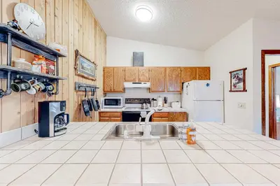 a kitchen with a sink and a refrigerator at Cozy Corner in Winter Park