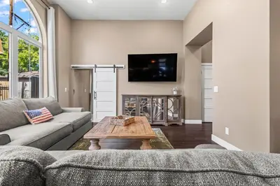 a living room with a couch and a table at Stylish Church Conversion Walk to LoHi in Denver