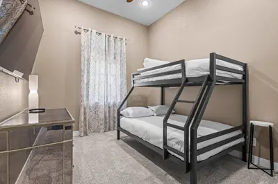 a bedroom with two bunk beds and a window at Stylish Church Conversion Walk to LoHi in Denver